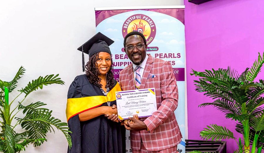 Linet Murugi receiving a certificate at Beautiful Pearls Ministries graduation